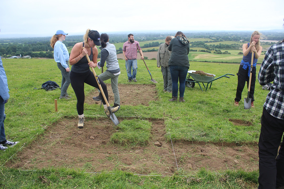 students removing turf from a field site
