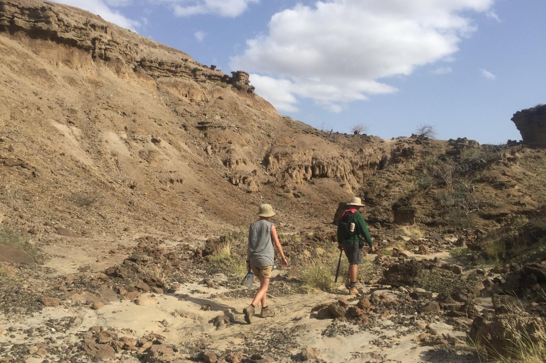 People walking through ditch