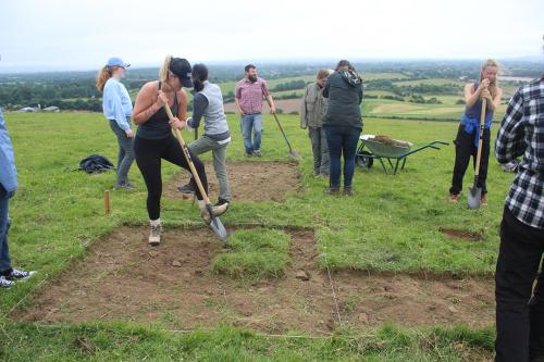 students removing turf from a field site
