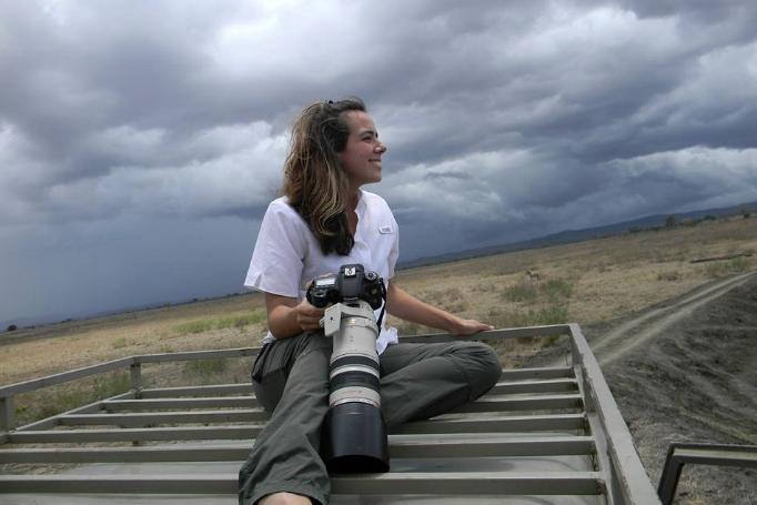 student with long-lens camera